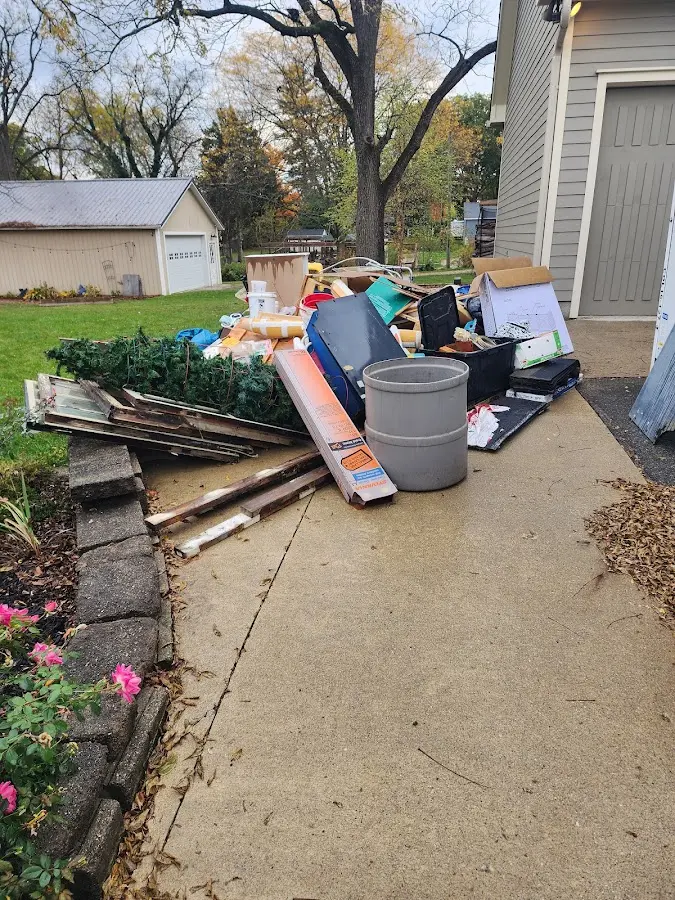 Dumpster being loaded with debris for 10 Yard Dumpster Rental in Anahola
